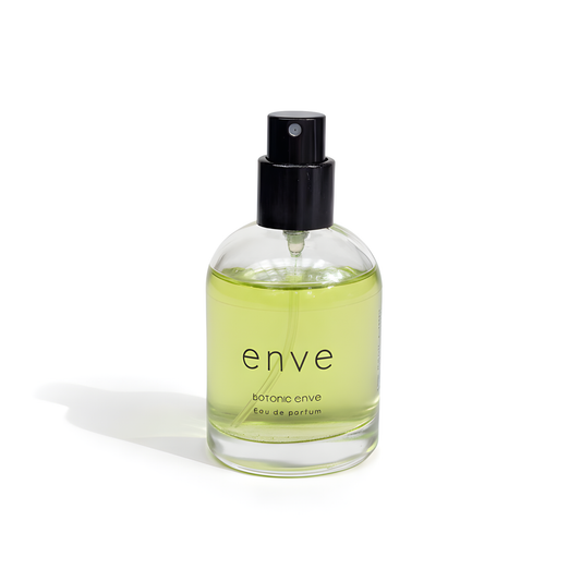 Clear bottle of 'enve' botanical perfume with a black spray nozzle on a white background