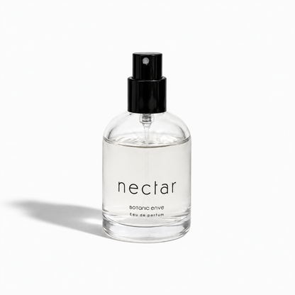 Clear spray bottle labeled 'nectar' on a white background